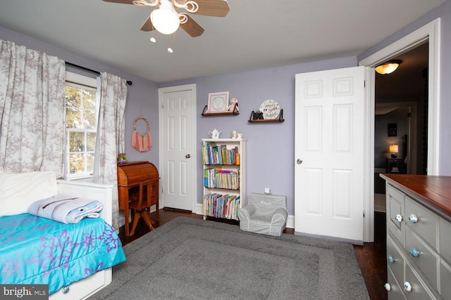 bedroom with ceiling fan and dark hardwood / wood-style flooring