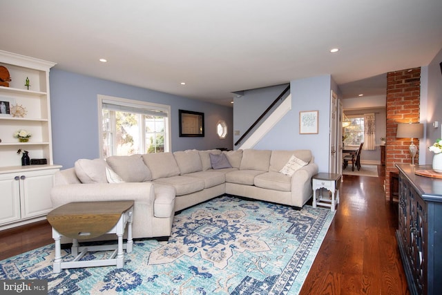 living room featuring plenty of natural light and dark hardwood / wood-style floors