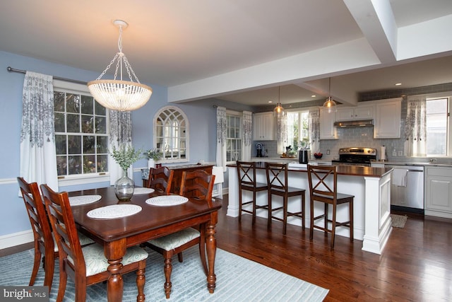 dining space with dark hardwood / wood-style flooring and a chandelier