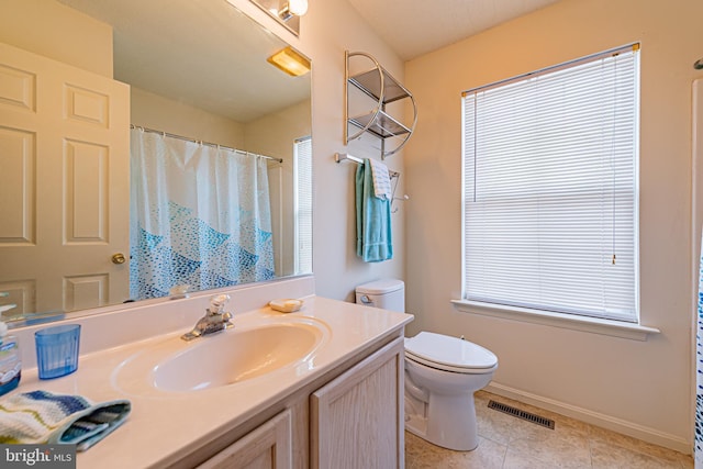 bathroom with vanity, tile patterned floors, and toilet