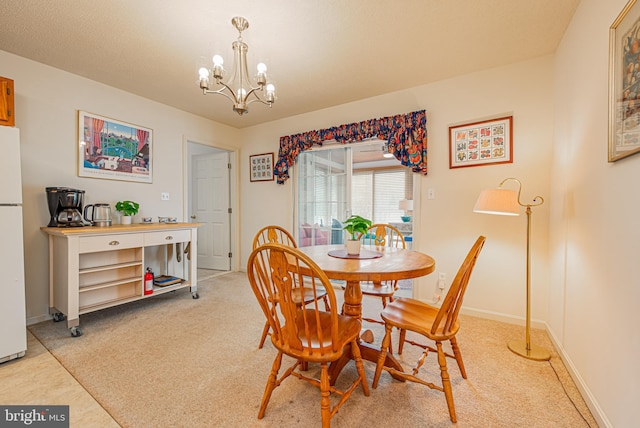 carpeted dining room featuring a chandelier