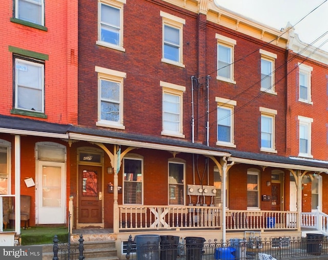 view of front facade with a porch and brick siding