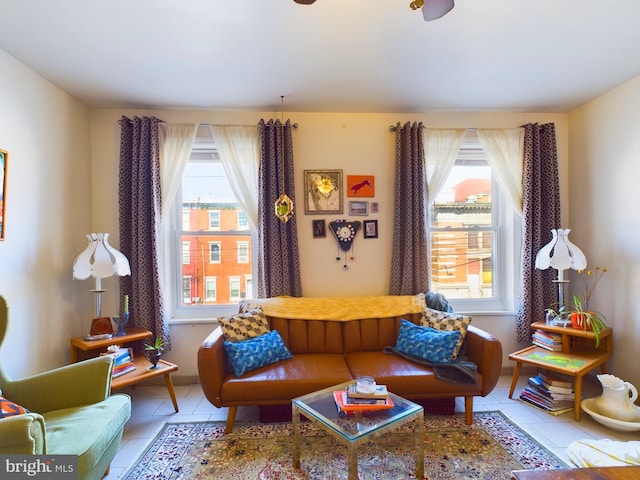 living area featuring a wealth of natural light and tile patterned flooring