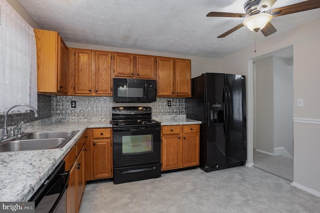 kitchen with sink, black appliances, a textured ceiling, ceiling fan, and backsplash