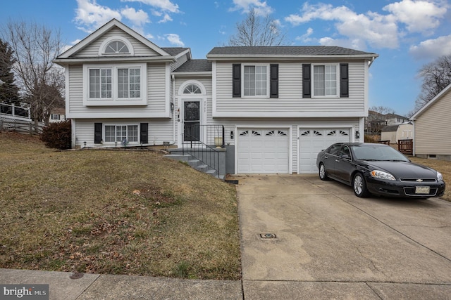 bi-level home with a garage and a front yard