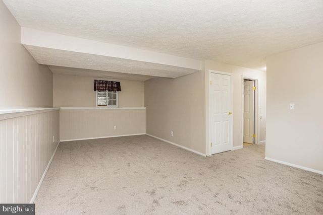 basement featuring carpet and a textured ceiling