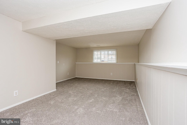 unfurnished room featuring light carpet and a textured ceiling