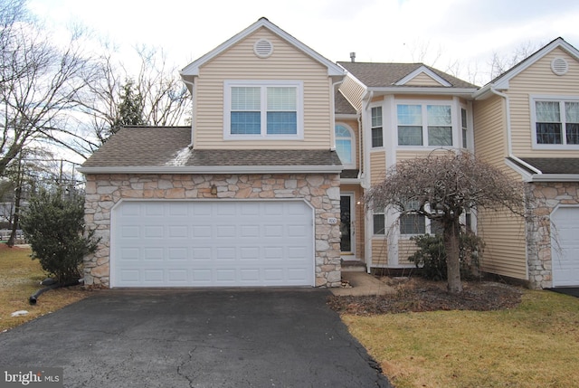 view of front of home with a garage and a front yard