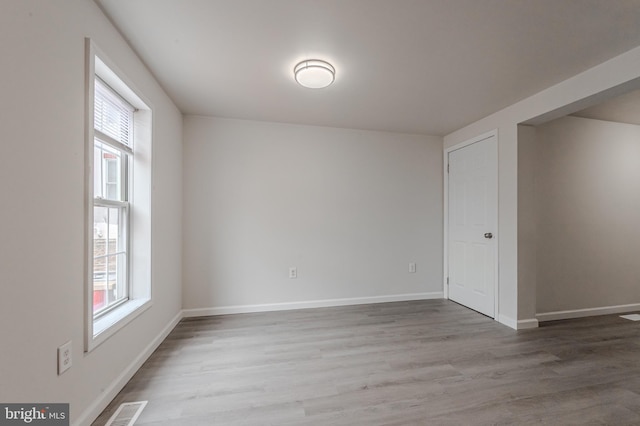 empty room with hardwood / wood-style flooring