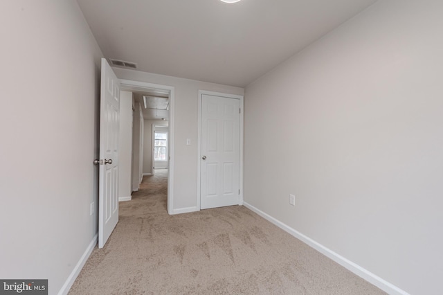 unfurnished bedroom with light colored carpet