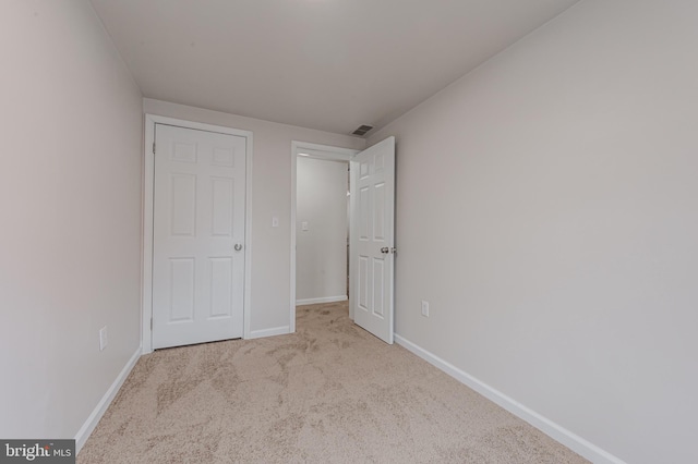 unfurnished bedroom with light carpet