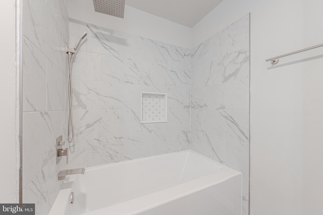 bathroom featuring tiled shower / bath