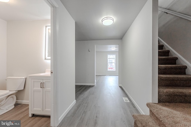 hallway with light hardwood / wood-style floors