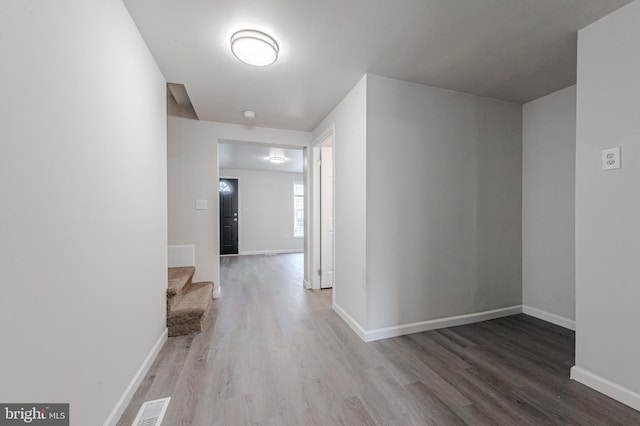 hall with hardwood / wood-style floors