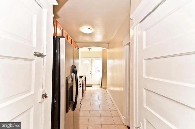 hall with light tile patterned floors