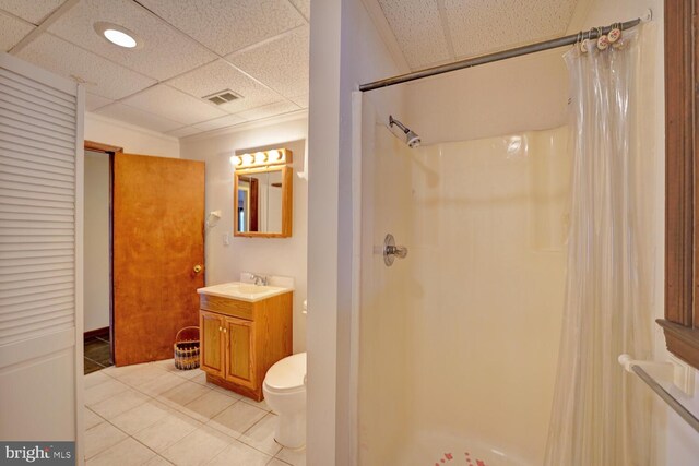 338 Blue Heron Rd, Dover, DE 19904 - bathroom with a paneled ceiling, vanity, tile patterned flooring, and a shower with shower curtain