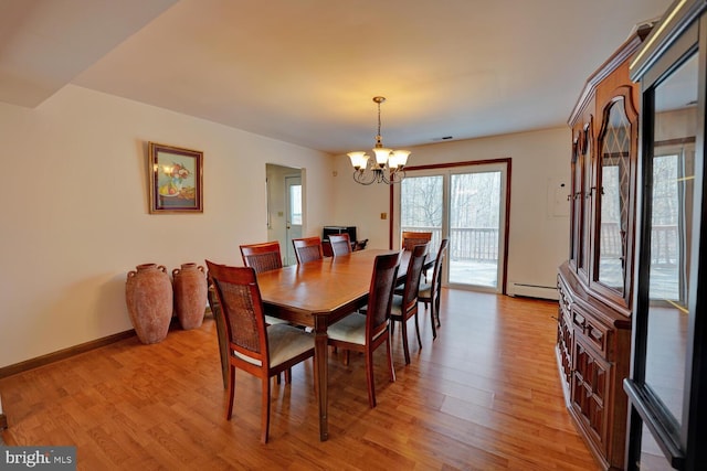 338 Blue Heron Rd, Dover, DE 19904 - dining space featuring baseboard heating, light hardwood / wood-style flooring, and a notable chandelier