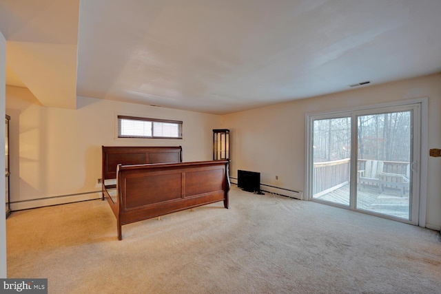 338 Blue Heron Rd, Dover, DE 19904 - bedroom with light carpet, access to outside, and baseboard heating