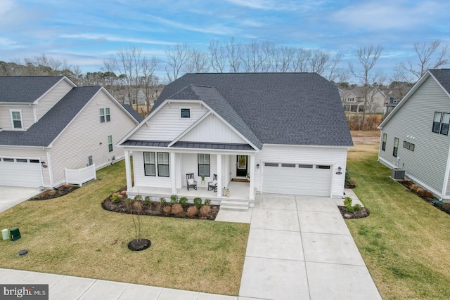 view of front facade featuring a garage, central AC, a front lawn, and a porch