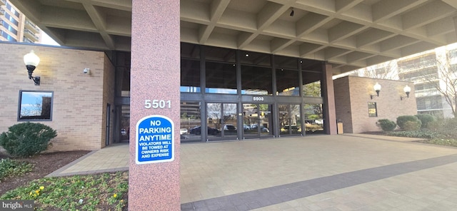 view of exterior entry featuring brick siding