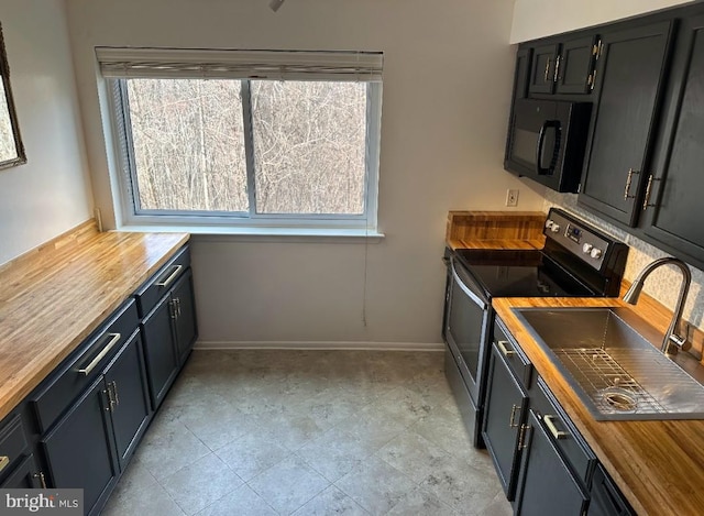 kitchen with butcher block counters, sink, and stainless steel range with electric cooktop