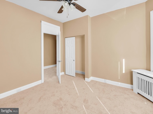 unfurnished bedroom with carpet floors, ceiling fan, and a closet