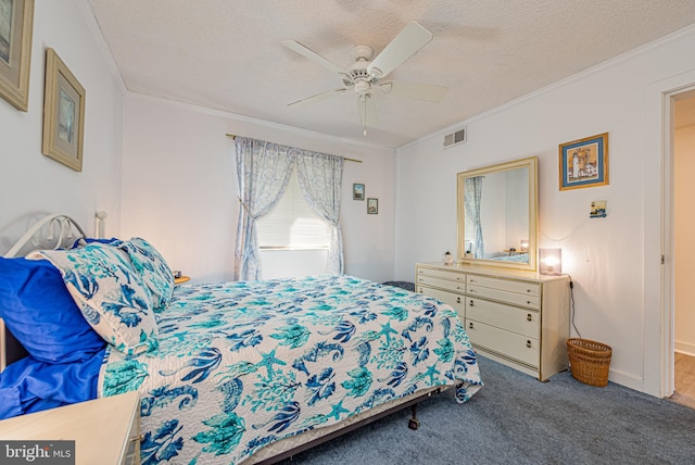 bedroom with crown molding, carpet floors, ceiling fan, and a textured ceiling