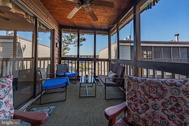 sunroom featuring wood ceiling, plenty of natural light, and ceiling fan