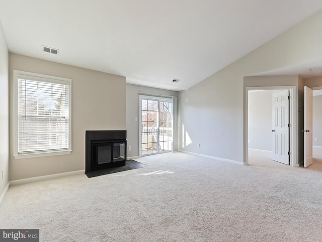 unfurnished living room featuring lofted ceiling and light colored carpet