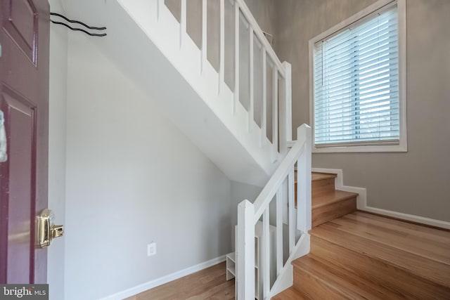 stairway featuring baseboards and wood finished floors