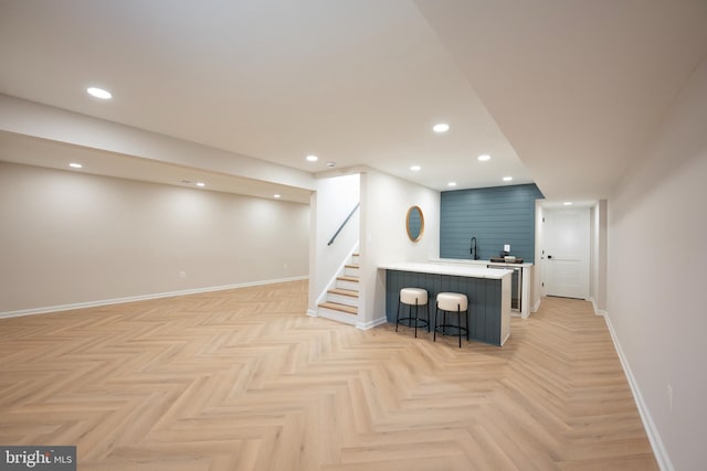 bar featuring stairway, recessed lighting, wet bar, and baseboards