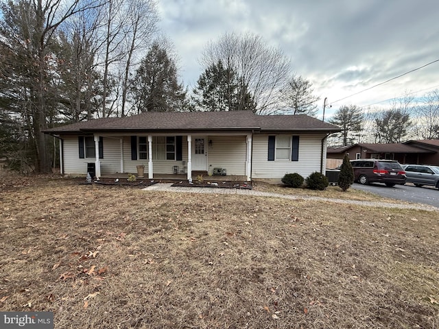 ranch-style home with a porch and a front lawn