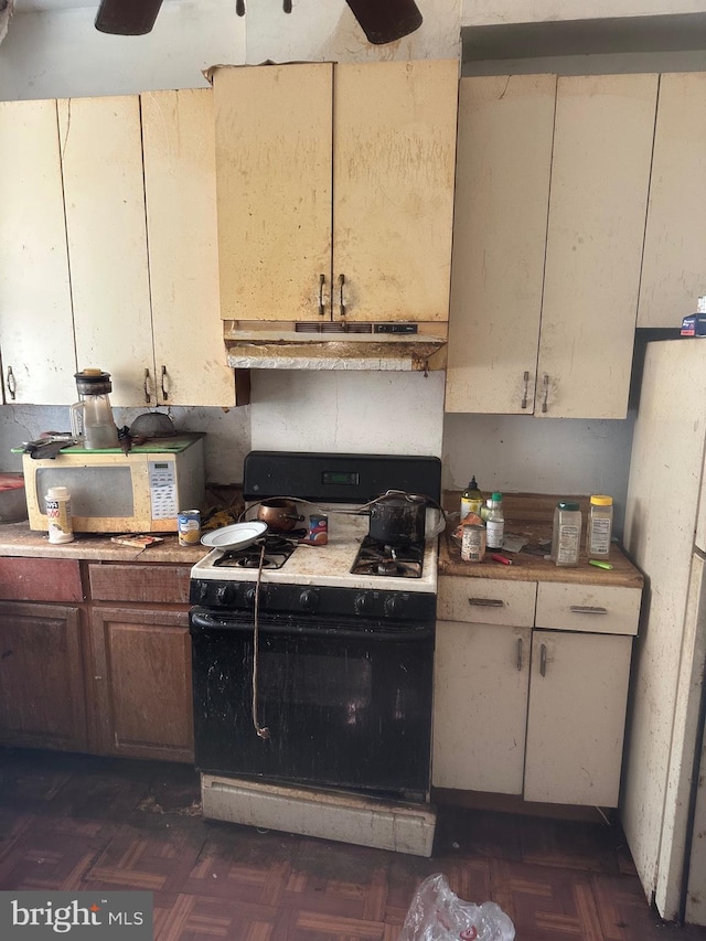 kitchen featuring gas stove and dark parquet floors