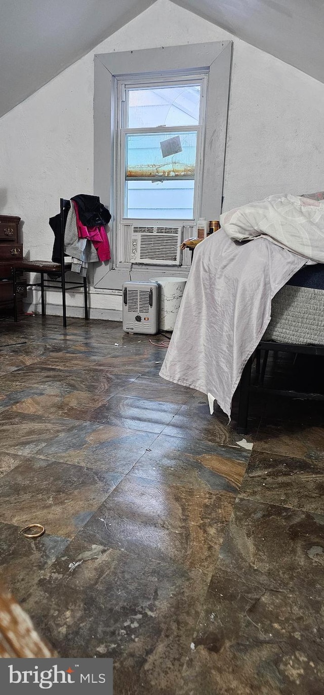 bedroom featuring vaulted ceiling and cooling unit