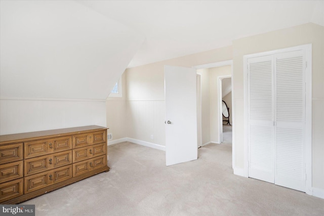 additional living space with lofted ceiling and light colored carpet