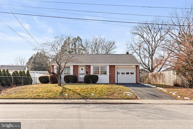 view of front of home with a garage and a front lawn