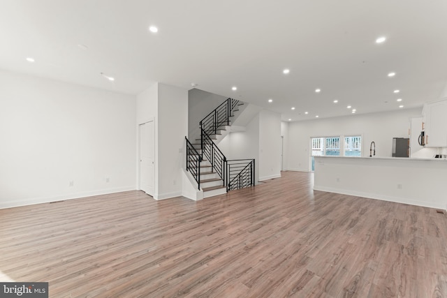 unfurnished living room featuring light wood-type flooring