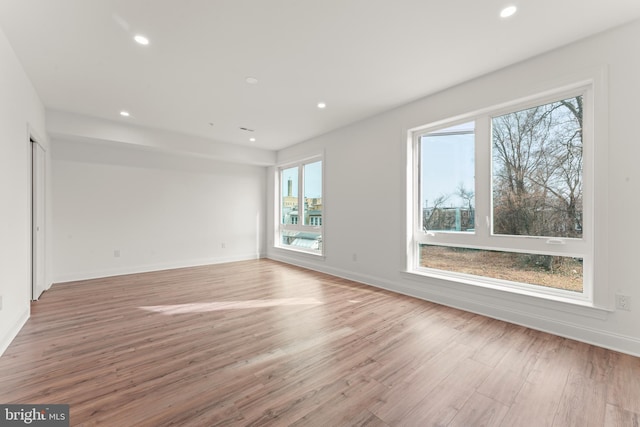 unfurnished room with light wood-type flooring