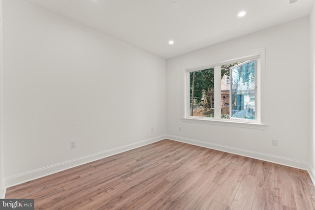 unfurnished room with light hardwood / wood-style flooring