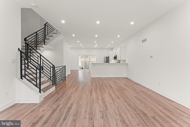 unfurnished living room with light wood-type flooring