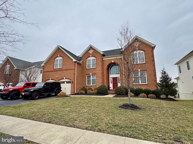 view of front property with a garage and a front yard