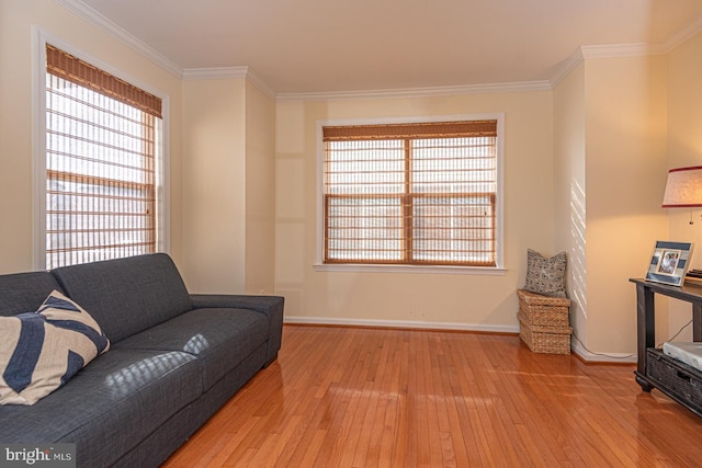 sitting room featuring crown molding and light wood-type flooring