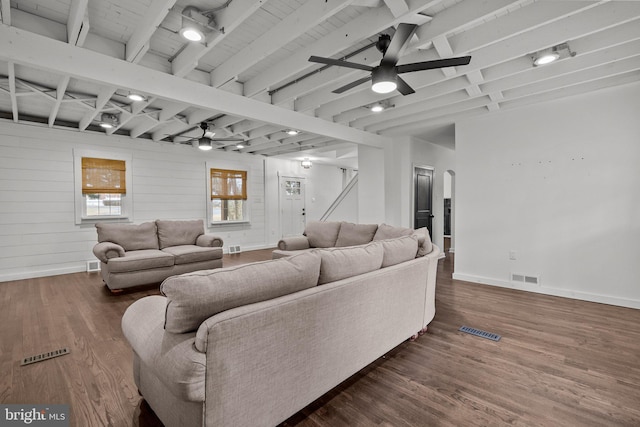 living room featuring beam ceiling, dark hardwood / wood-style floors, and ceiling fan