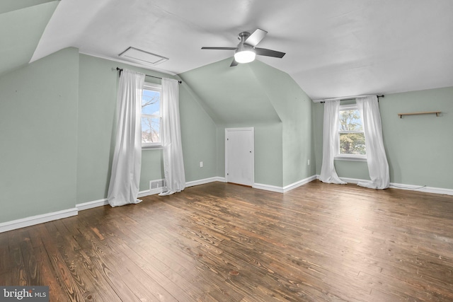 additional living space with lofted ceiling, dark hardwood / wood-style floors, and a wealth of natural light