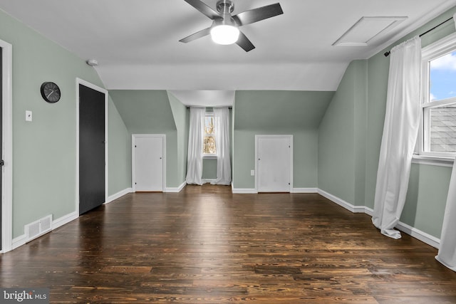 bonus room with lofted ceiling, dark wood-type flooring, and a wealth of natural light