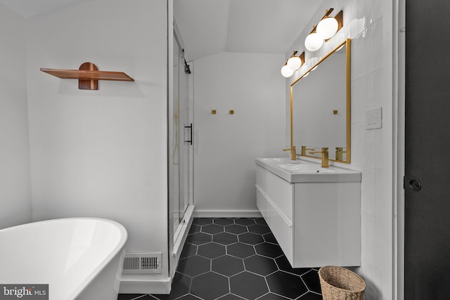 bathroom with vanity, vaulted ceiling, tile patterned floors, and independent shower and bath