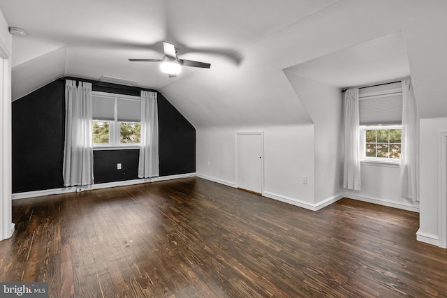 additional living space with vaulted ceiling, dark hardwood / wood-style floors, and ceiling fan