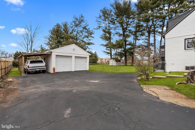 garage featuring a lawn