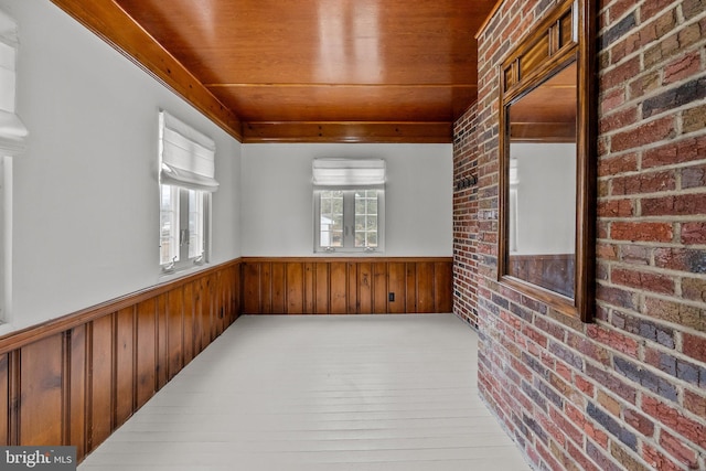 sunroom with plenty of natural light and wood ceiling