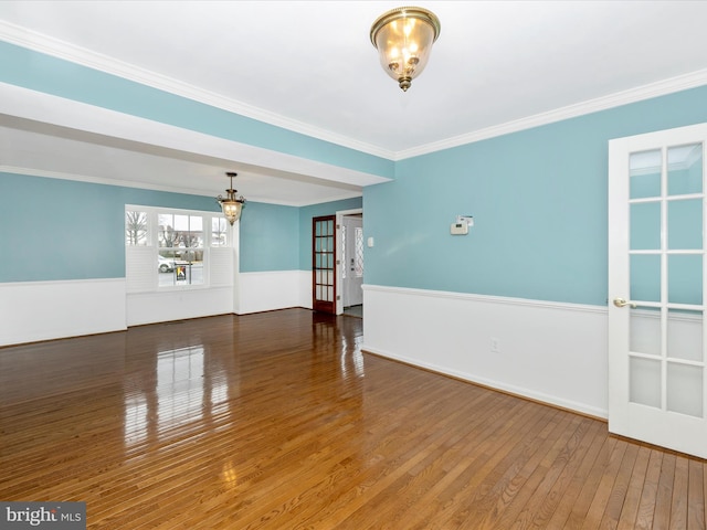 spare room featuring crown molding and dark hardwood / wood-style floors